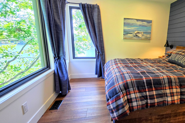 Main floor 2nd bedroom with corner window view of Lac McGregor