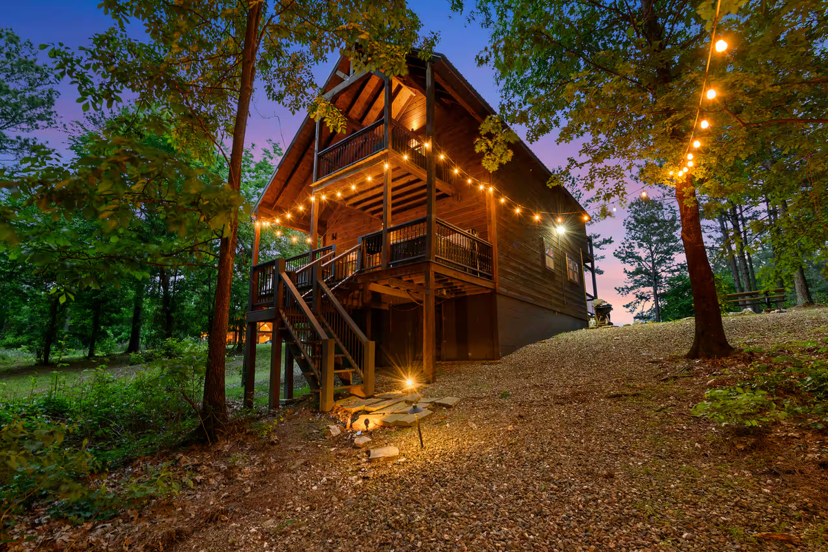 Exterior: Twinkling lights set the stage for magical evenings in wooded serenity!