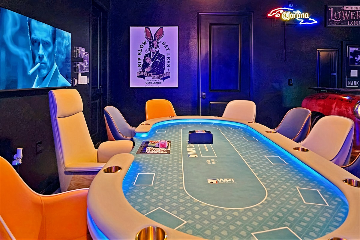 Ultimate game room featuring Vegas style poker table with 10 leather chairs.