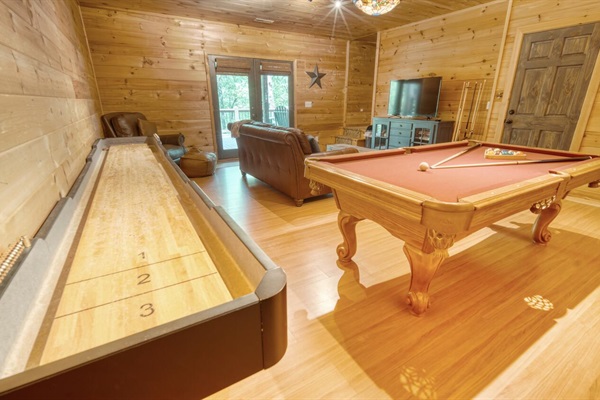 Game room with pool table, shuffle board, arcade games, and 50" smart tv