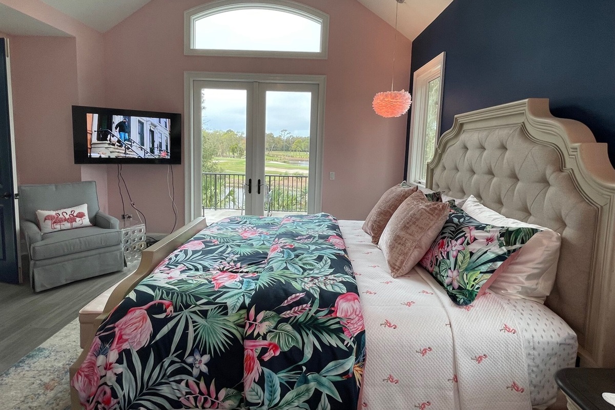 French doors open to 2nd floor balcony overlooking, pool, lagoon & golf course