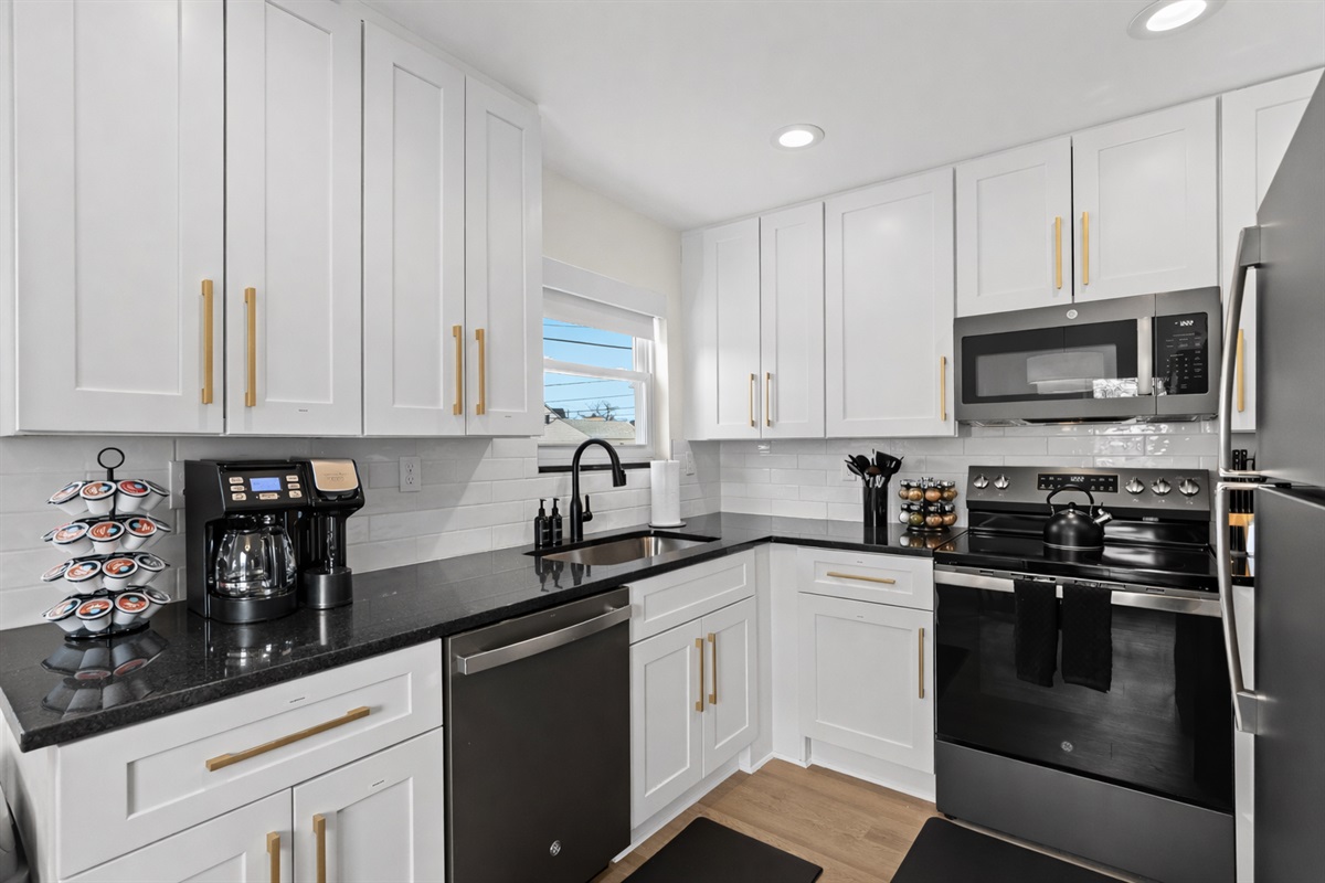 Bright, modern kitchen with full-size appliances, ample storage, and clean finishes—perfect for preparing meals and enjoying your stay with ease.