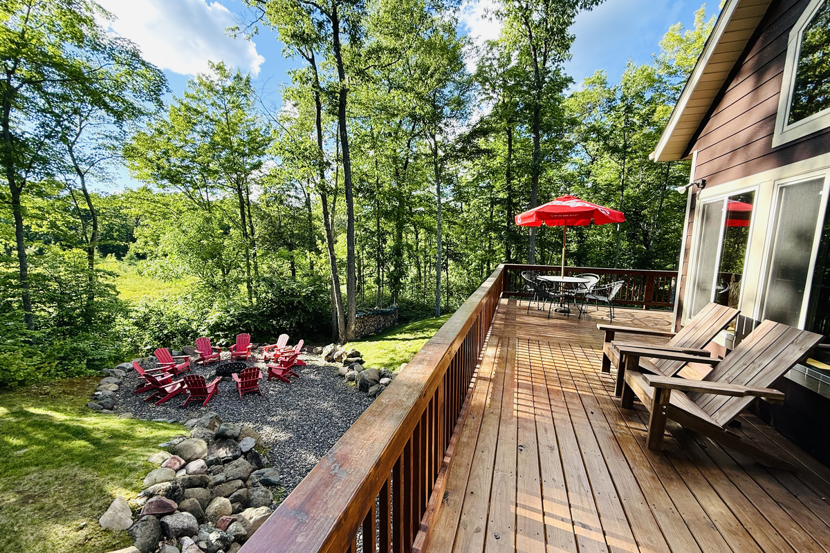 Deck overlooking the lake and fire pit area