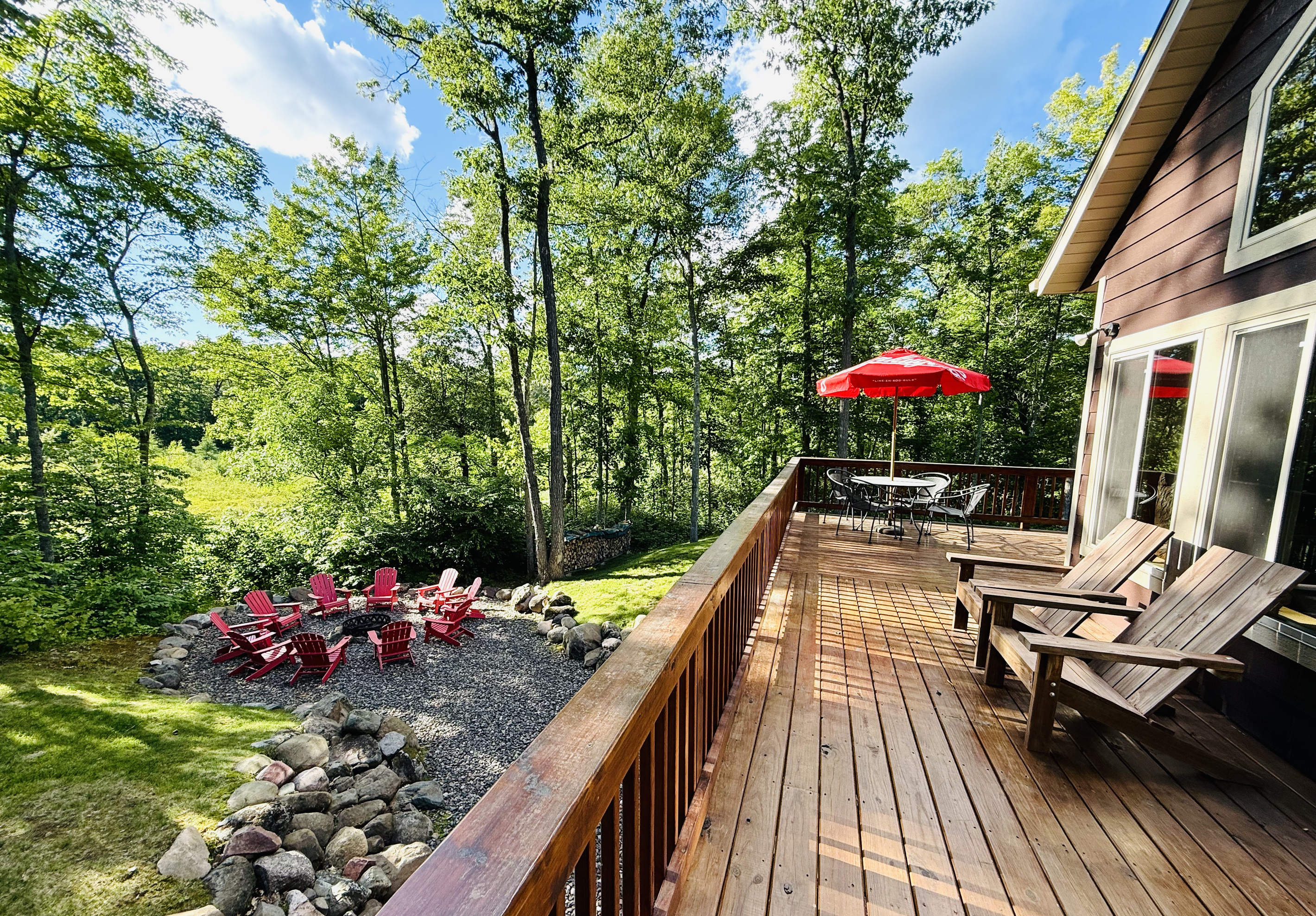 Deck overlooking the lake and fire pit area