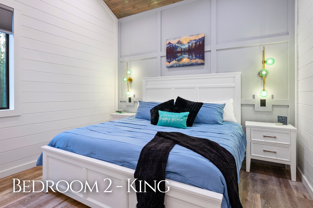 Cozy bedding, soft lighting, and a comfortable king bed make this bedroom a welcoming place to recharge after a full day of activities.