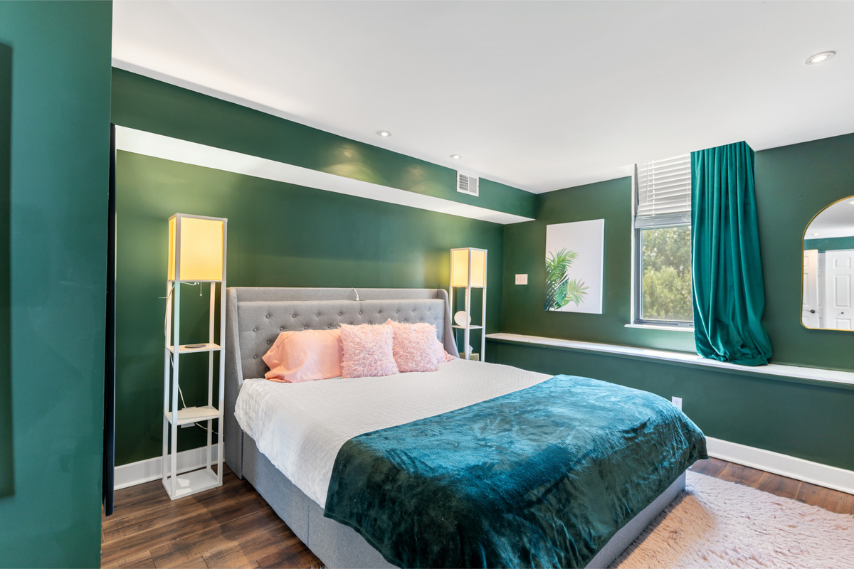 Deep greens and rich textures make this 2nd Floor King bedroom feel like a retreat of its own.