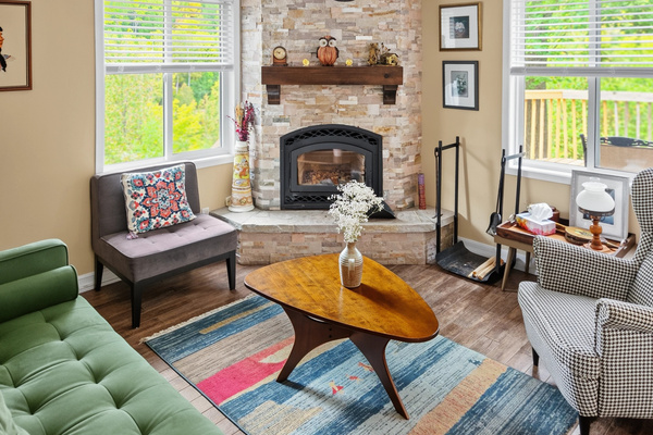 Living room seating area with wood-burning fireplace