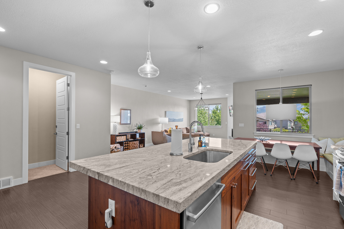 Modern kitchen with quartz countertops and open layout.