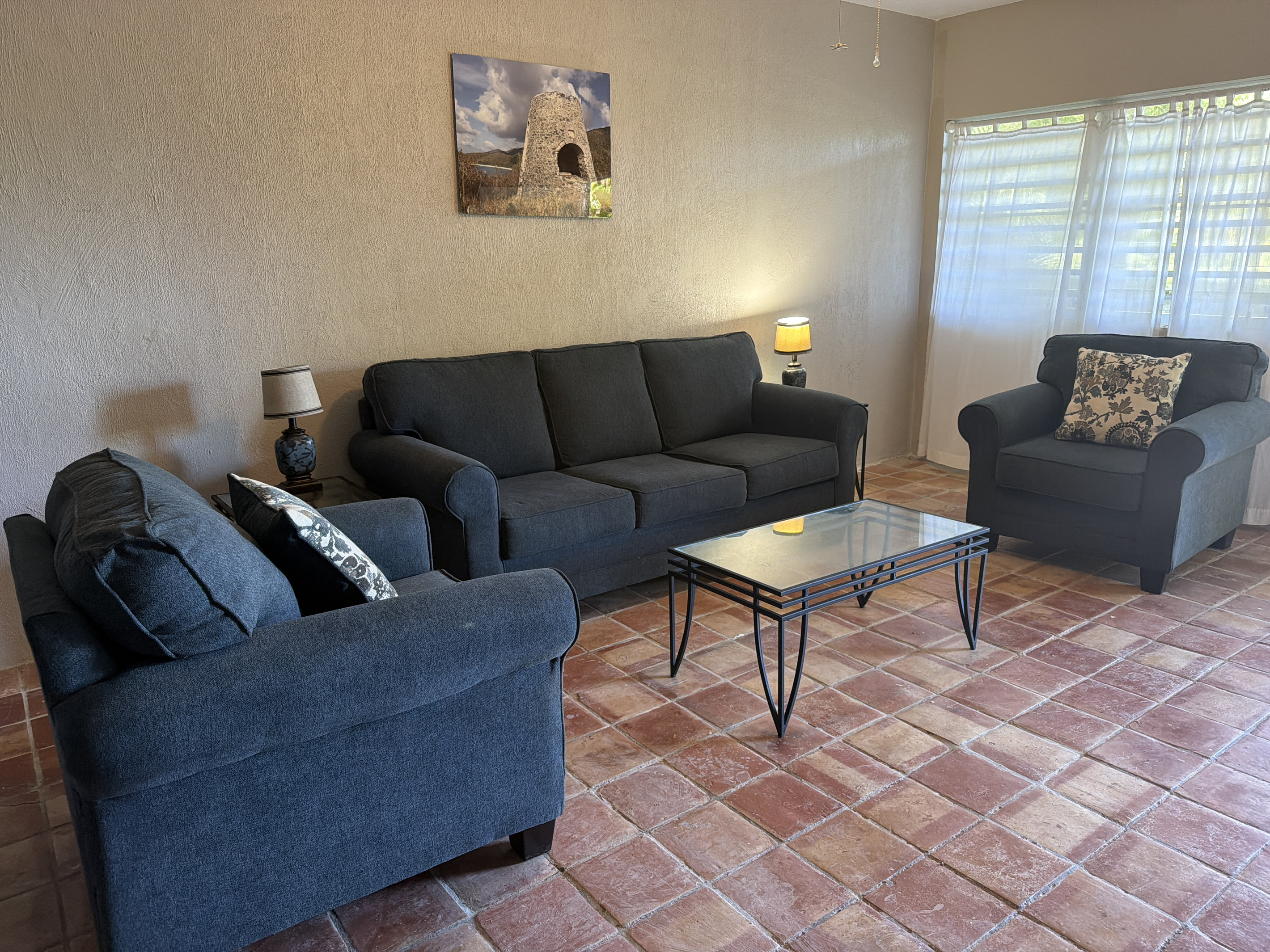 Relax in this open, airy living space equipped with flexible sleeping arrangements. Anchored by a comfortable pull-out sofa bed and two matching armchairs, it provides plenty of space to gather during the day and extra guest accommodations at night.