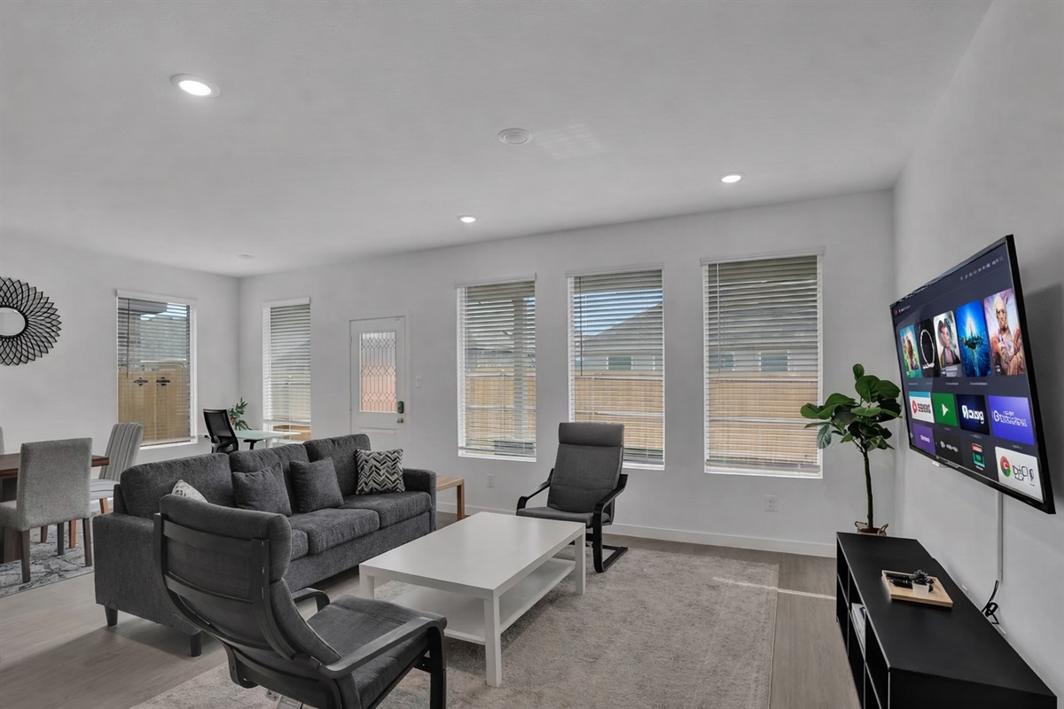 Spacious open-concept living room with smart TV — perfect for family time and relaxing after a day out