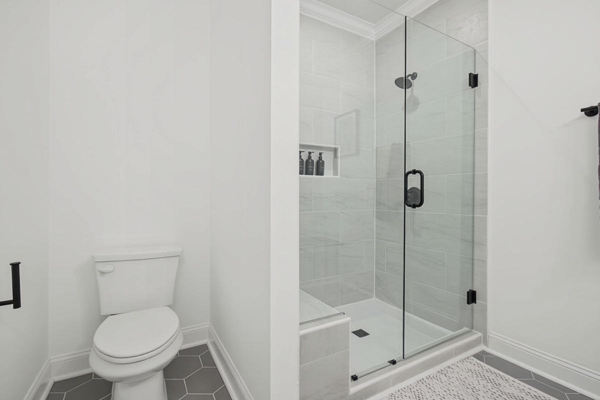 Walk-in tile shower with a private water closet
