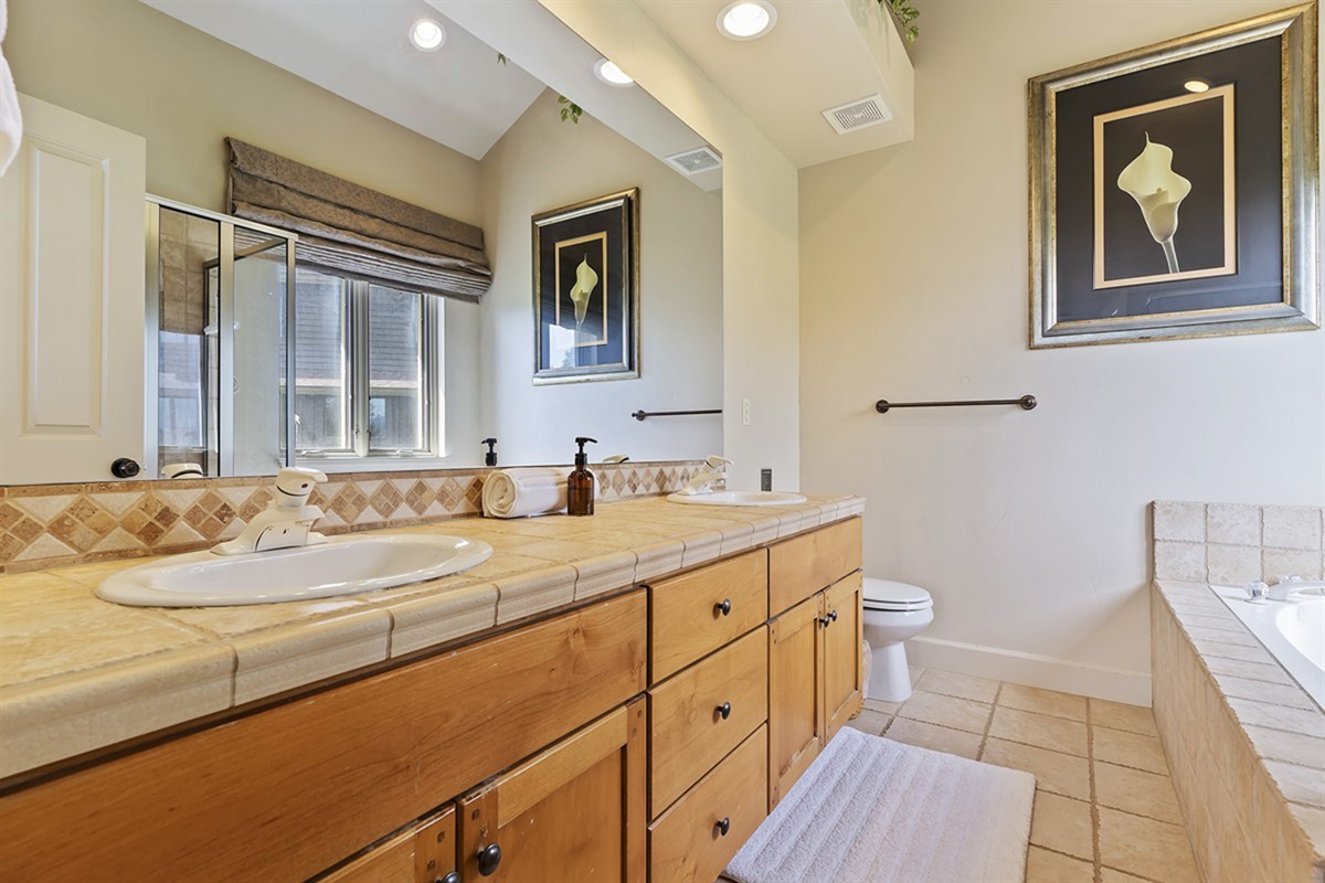 Lovely primary bathroom with double vanity and soaking tub