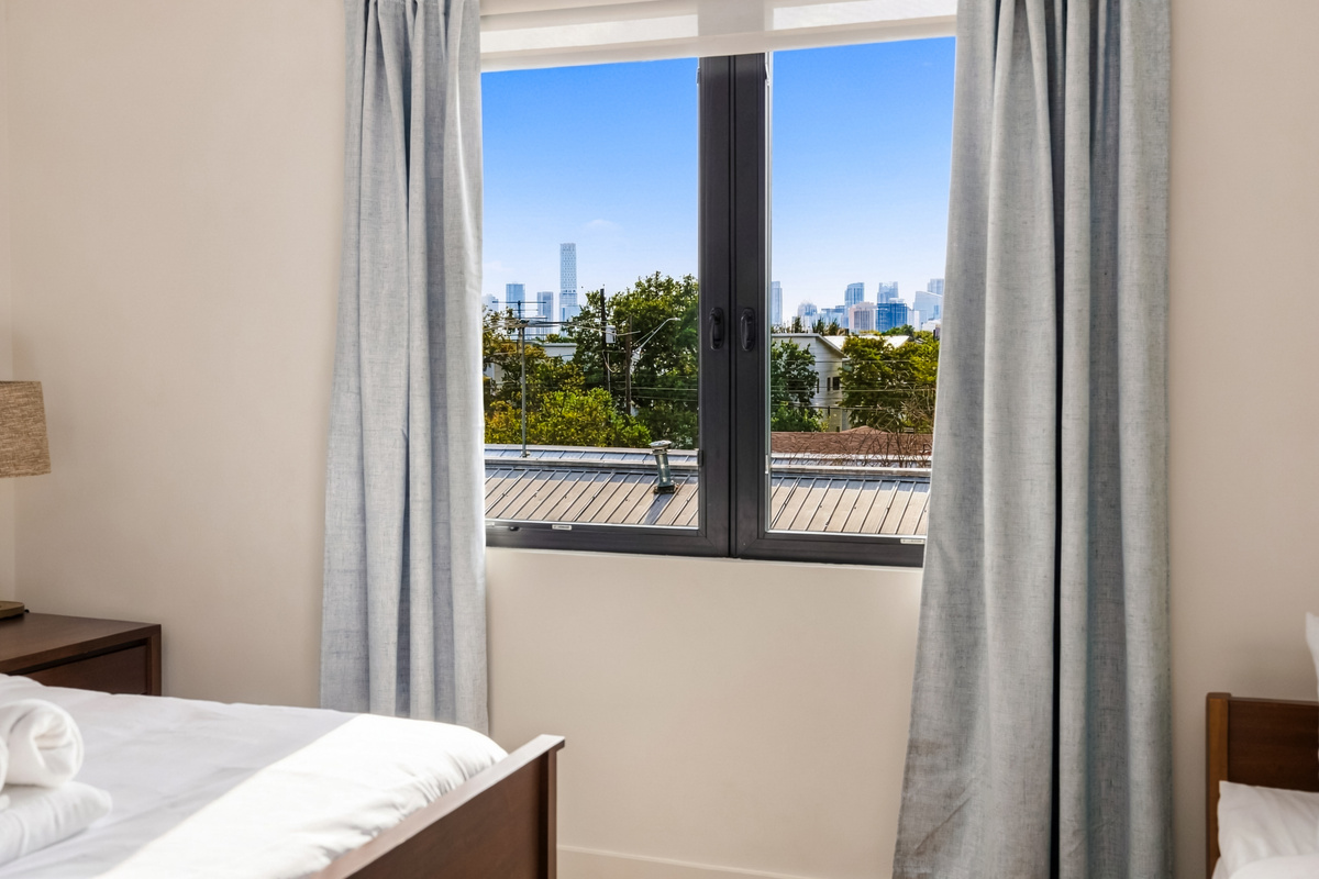 Wake up to downtown skyline views right from the primary suite.
