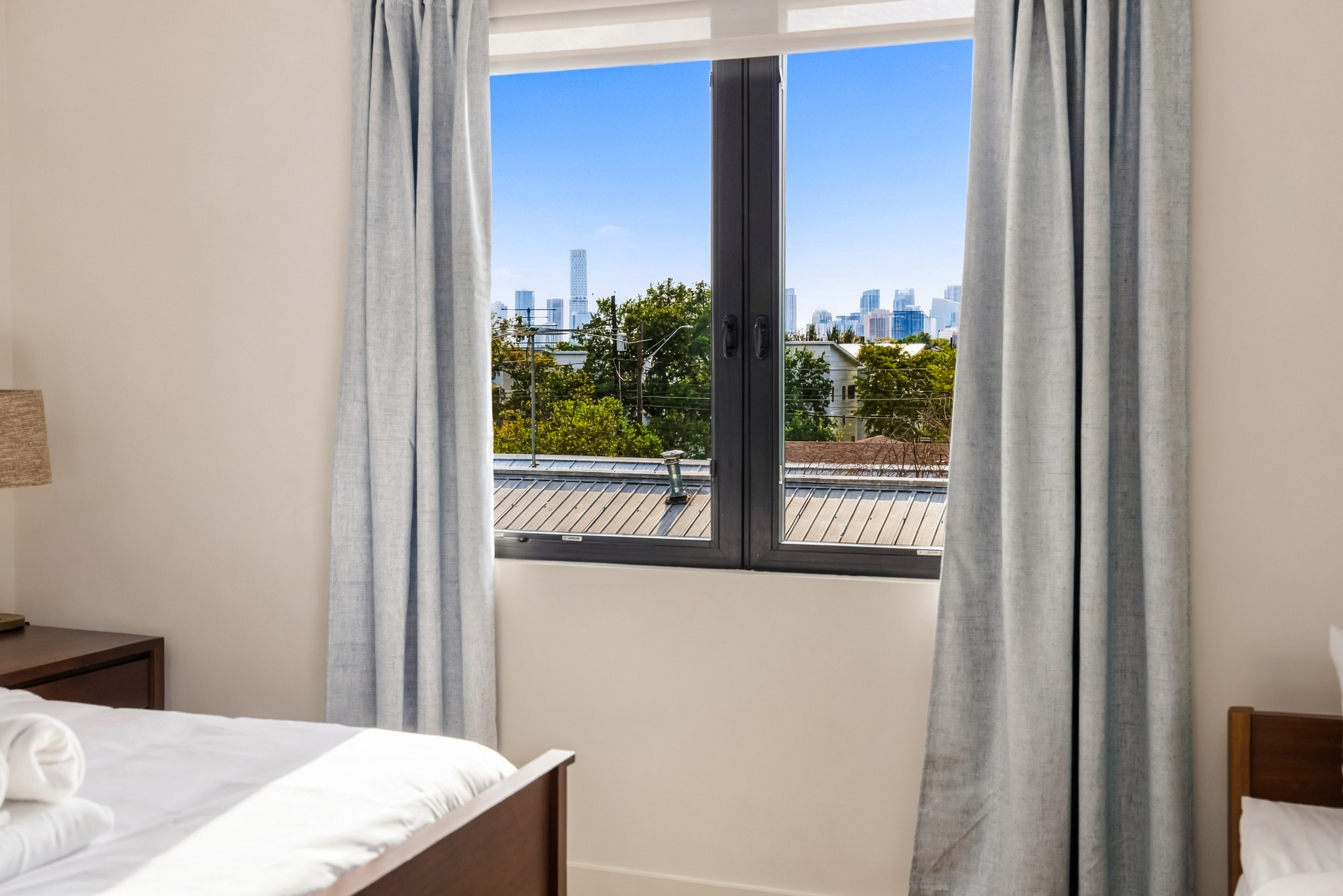 Wake up to downtown skyline views right from the primary suite.