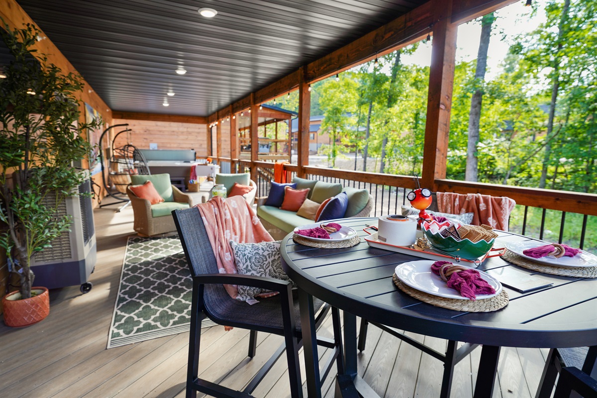 The covered and screened deck runs the length of the house for an entire outdoor living space, without the bugs