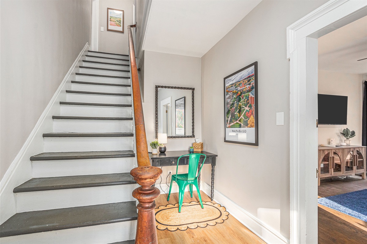 Shared foyer with stairs leading tot he upstairs units