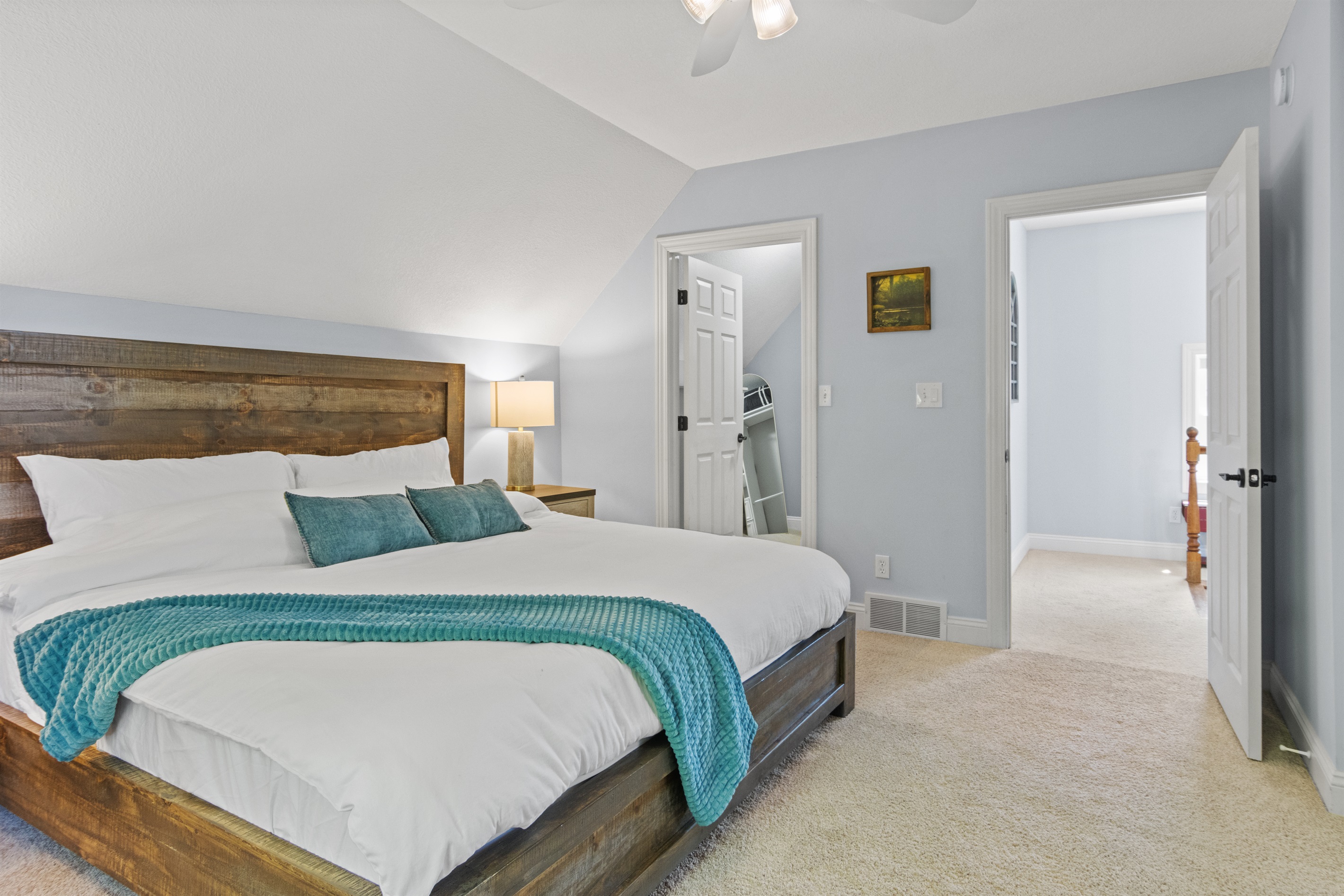 The first room you’ll find at the top of the stairs, featuring a king bed and a shared Jack-and-Jill bathroom connecting the bedrooms