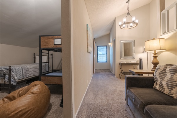 The kid's loft is at one end, and the queen bedroom is at the far end near the window.   Allowing for a bit of separation.