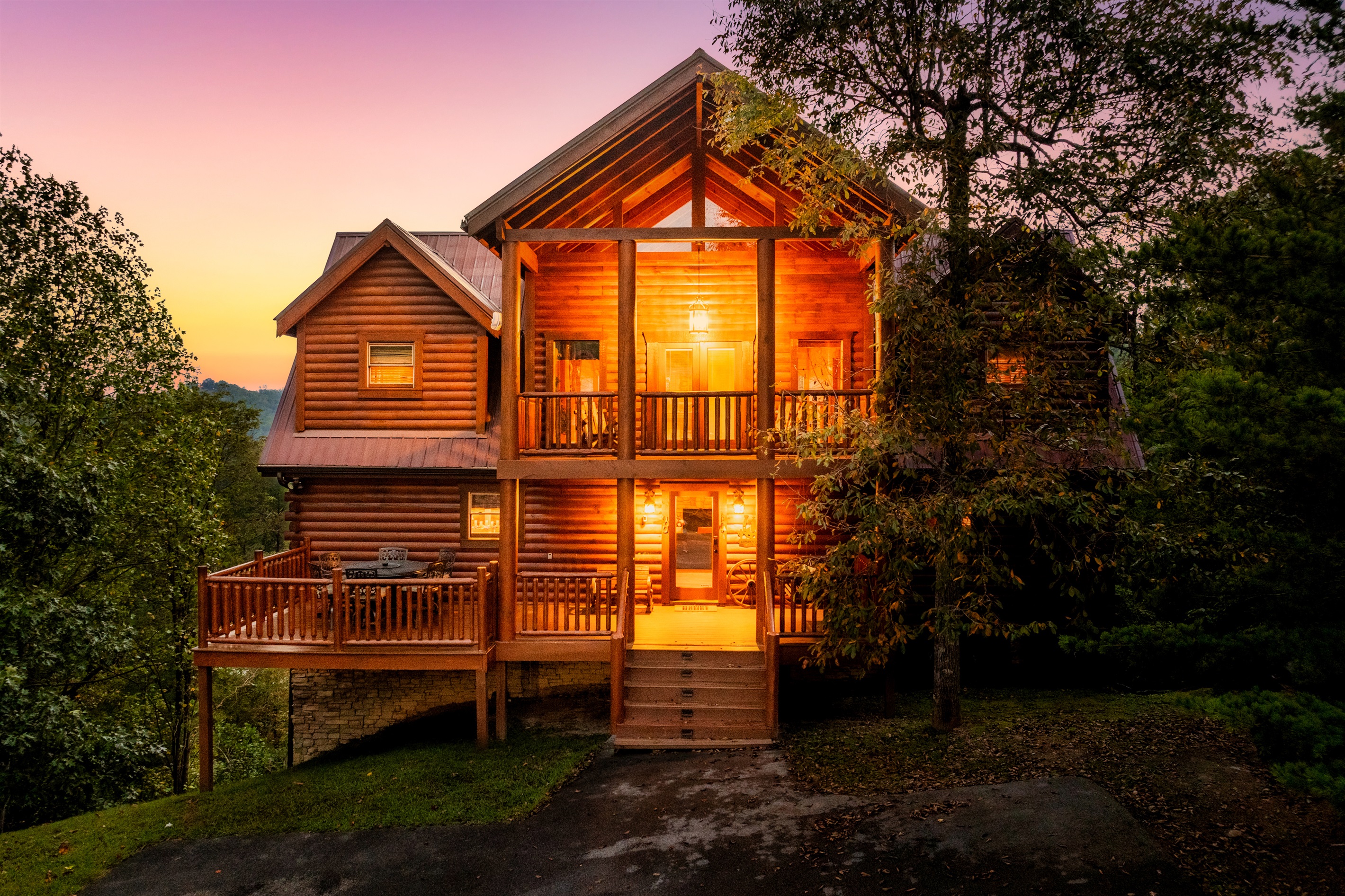 Front of cabin and partial view of driveway.  Parking for about 4 cars.