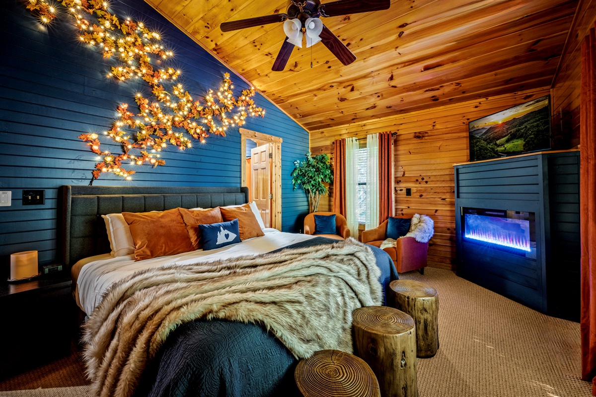Master en-suite bedroom with attached bathroom. King bed, seating, fireplace vibes, and roku streaming TV.