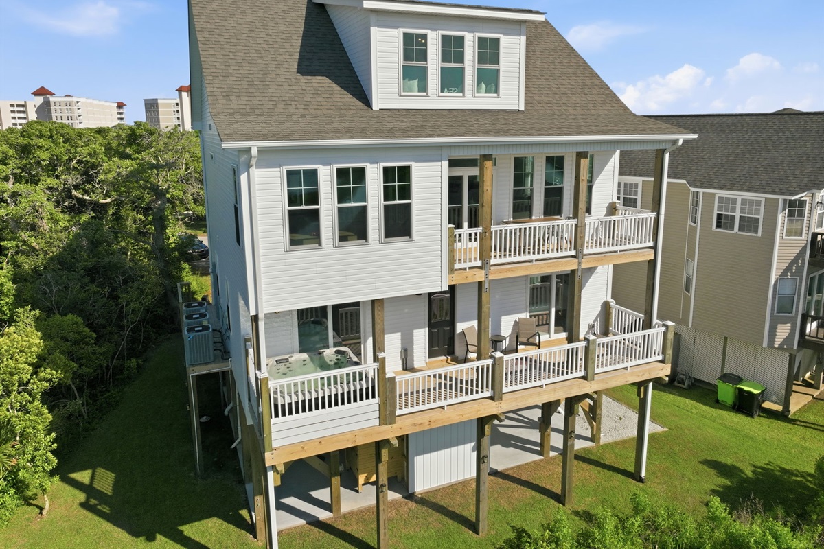 Multiple covered decks and a private hot tub perfect for relaxing after beach days