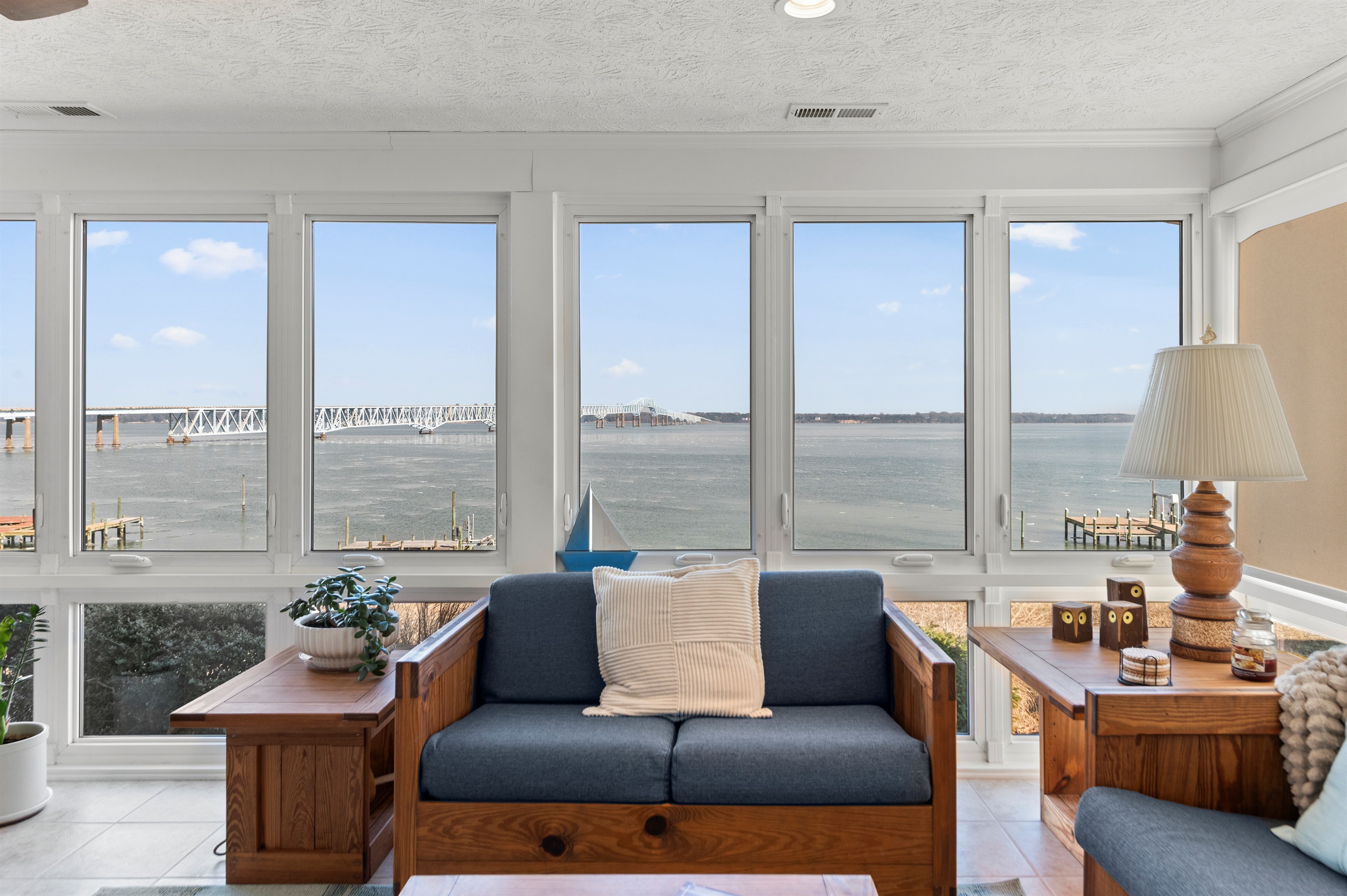 Sunroom Retreat: Breathtaking water views invite you to relax in style with comfy seating!