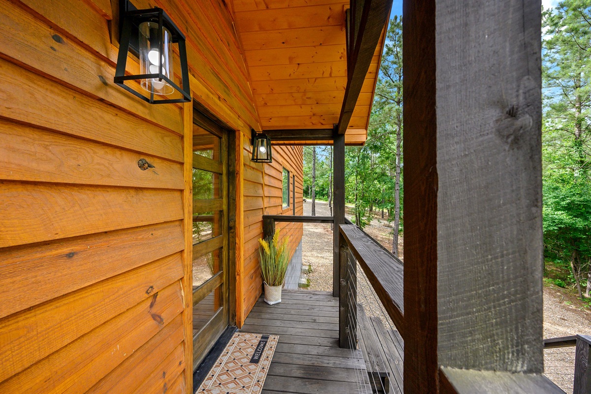 A covered entryway with rustic touches sets the tone for your cozy stay. Step inside and feel right at home.