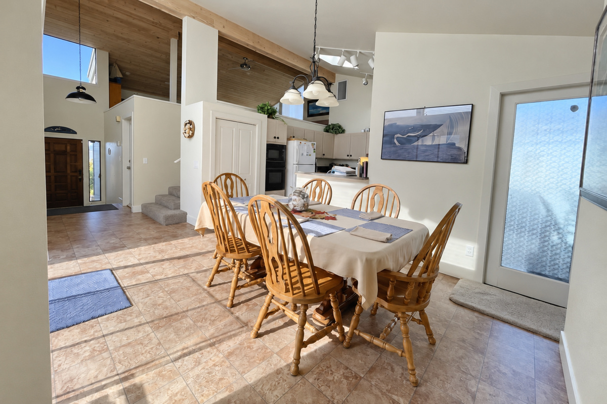 View from dining area looking up towards Living room. Vaulted Ceilings, open floorpan and numerous windows/skylights give home an open feel with lots of natural lighting.