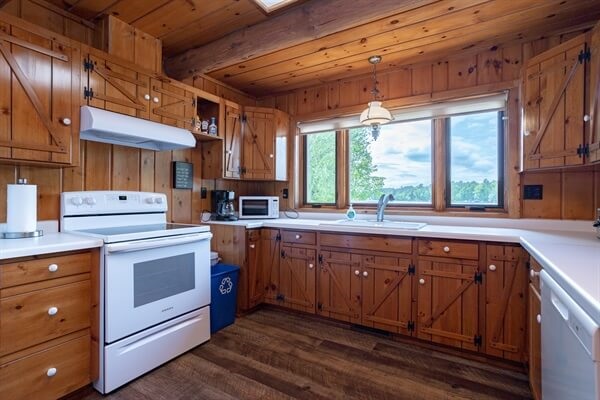 Large kitchen with view of the whole back yard and lake.