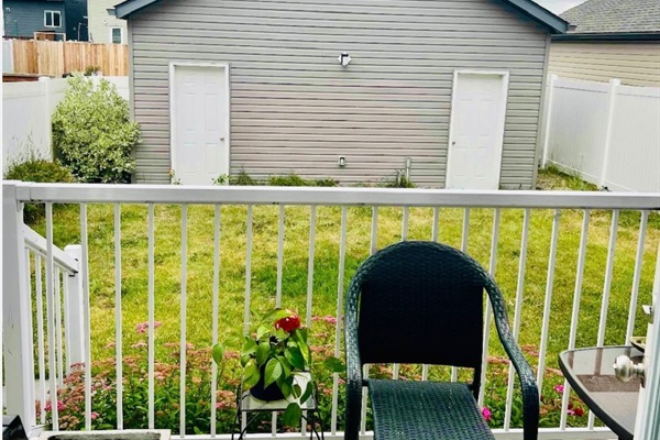 Cozy deck overlooking a fenced yard and detached garage
