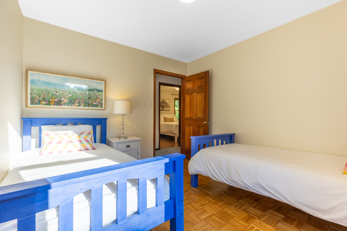 The twin bedroom is located next to and across the hall from two other bedrooms.