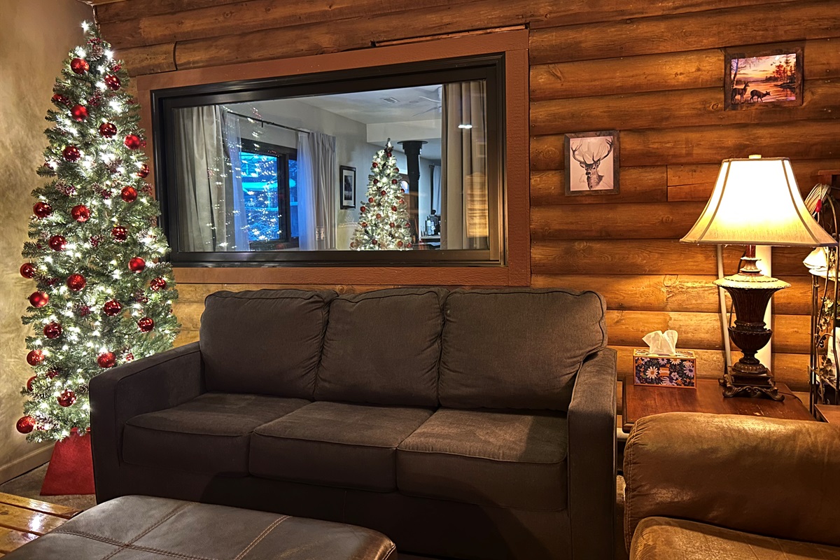 The decorated Christmas tree in the Sunroom and a view of the tree in the Guest Quarters.