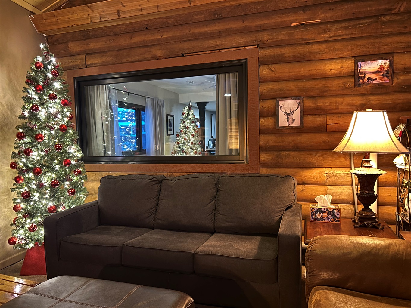 The decorated Christmas tree in the Sunroom and a view of the tree in the Guest Quarters.
