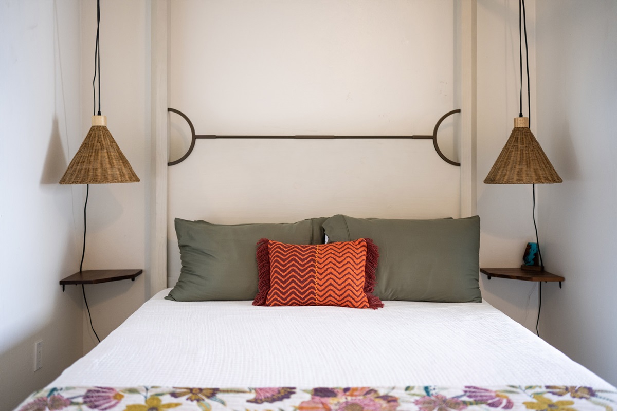 Artistic lighting and bedside storage for added functionality.