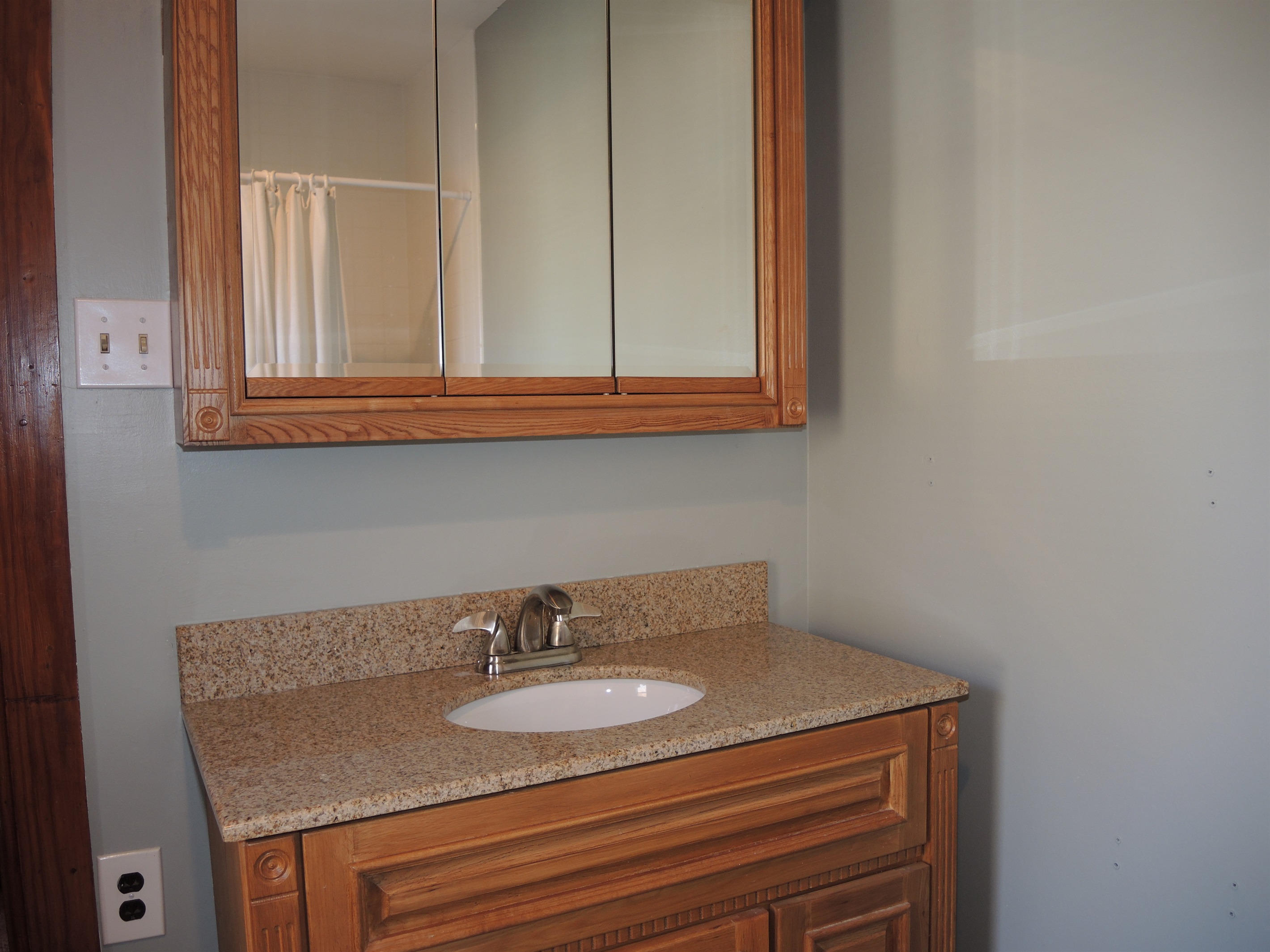 Full Bathroom with tub shower combo across the hallway from Queen bdrm suite.