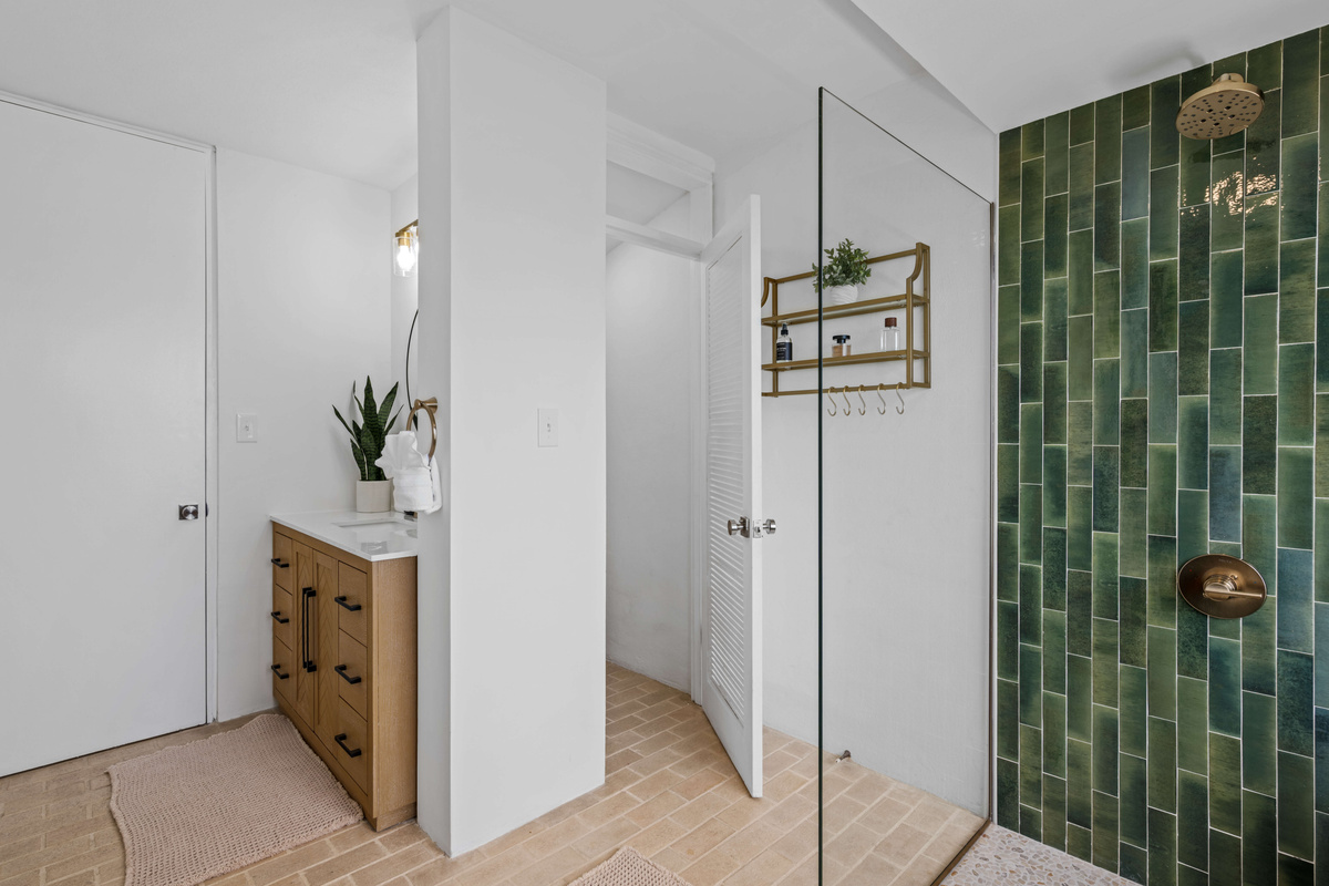 The toilet has its own door for privacy while someone is showering or getting ready. The door to the left is the entrance from the hallway.
