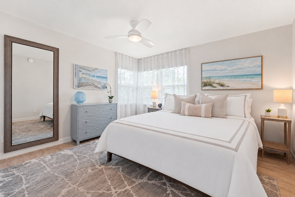 Serene primary bedroom with a king-size bed and relaxed coastal style.