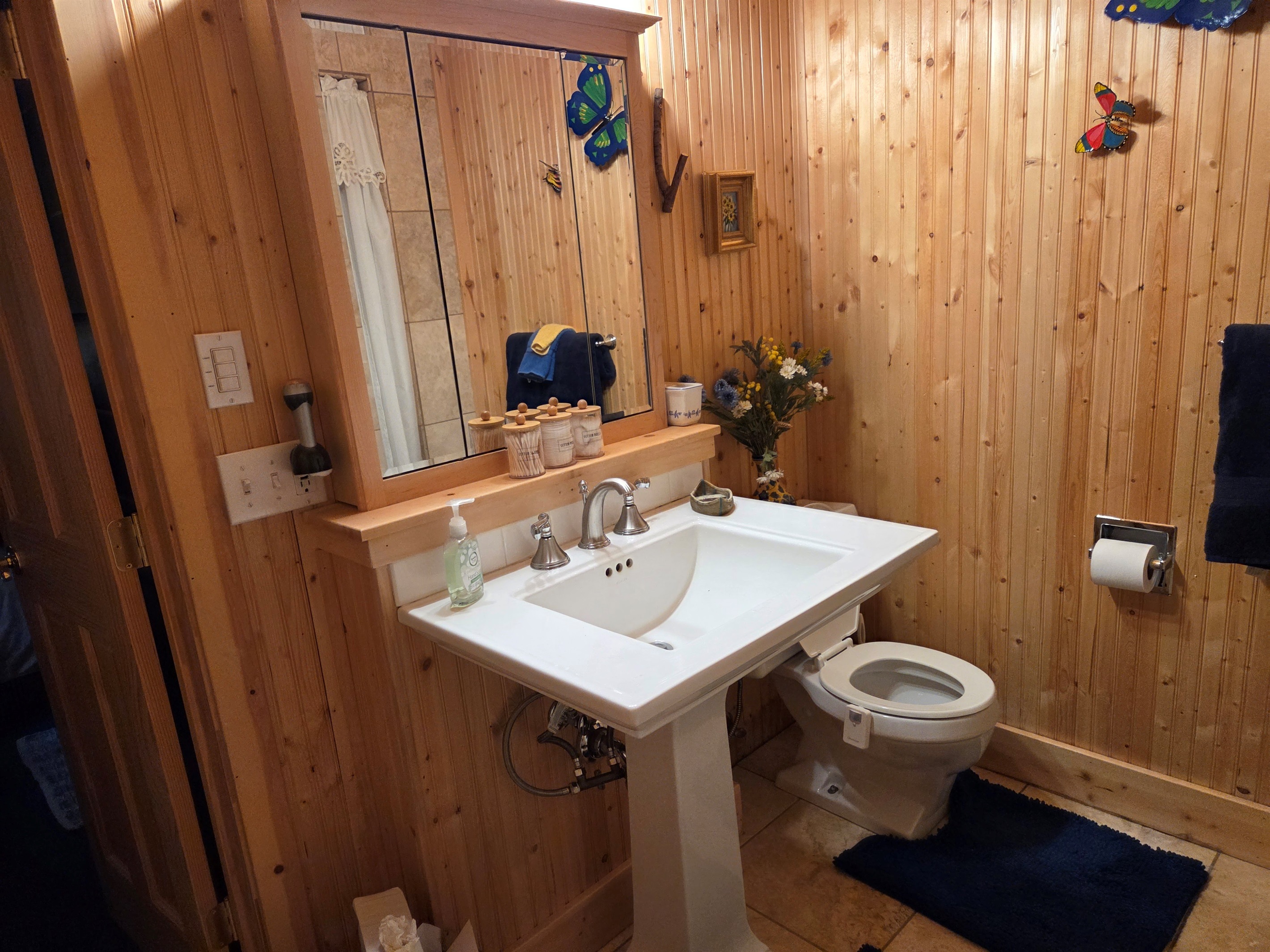 This ensuite bathroom for the master bedroom has storage and a jetted shower.