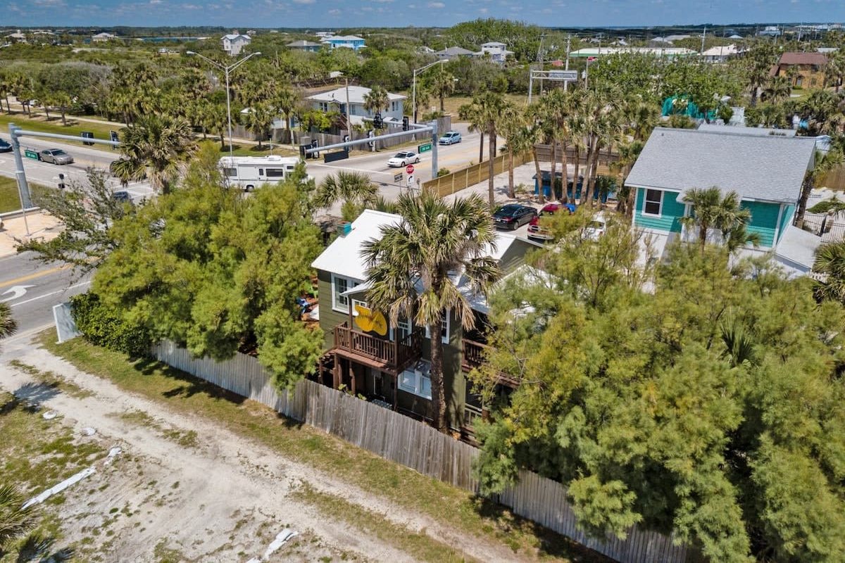 The lie of the land: the bungalow, its fenced courtyard, and the sandy path threading off towards the dunes. Everything you actually need on holiday sits comfortably inside a five-minute walk of the front door.