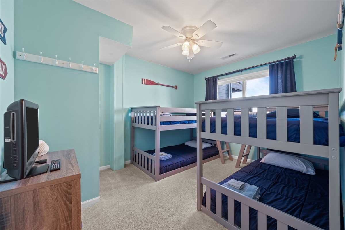 Fun kids bunk room with two twin bunk beds, giving everyone their own cozy spot to recharge after a day at the beach