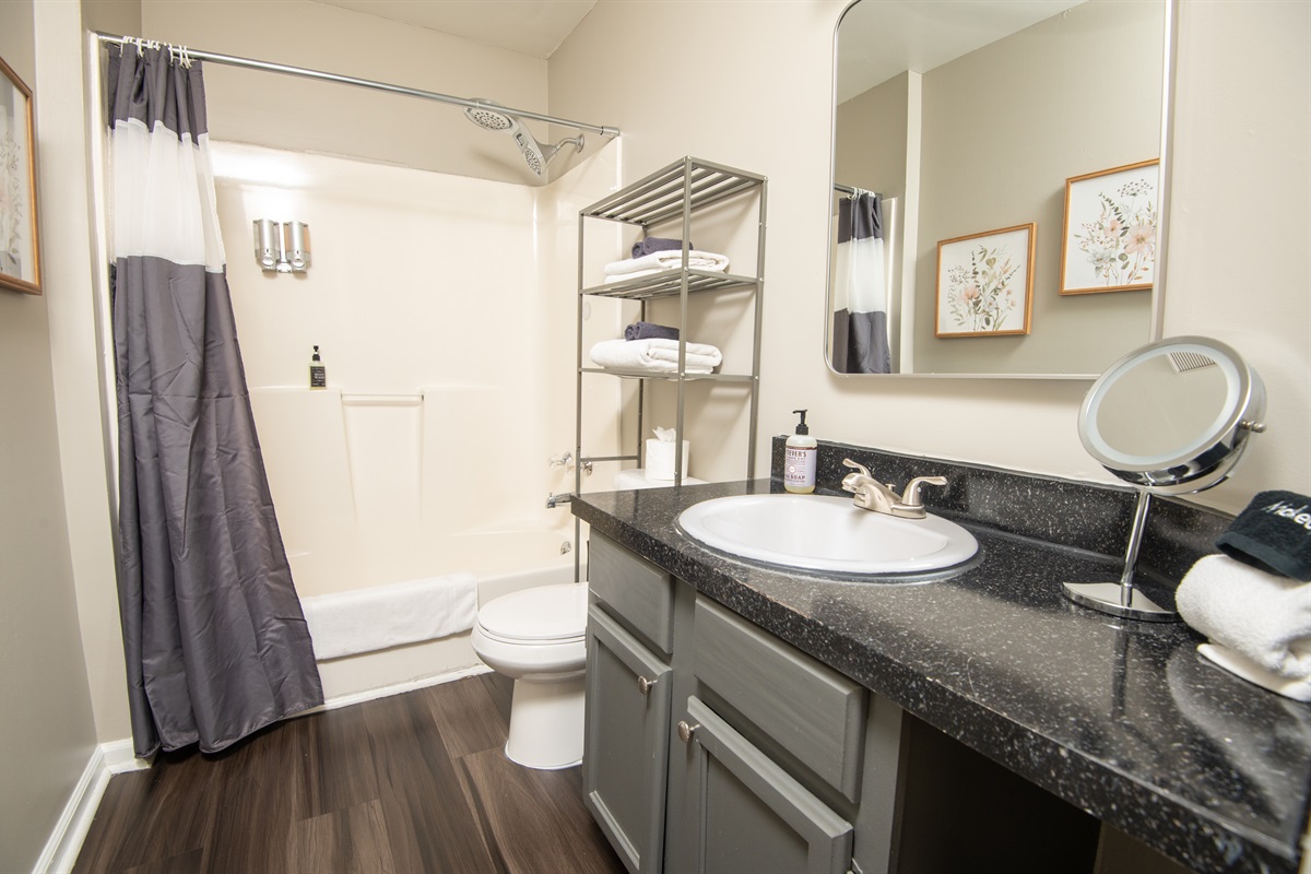 Here is Unit B's first full-sized bathroom located in the hallway. Bath and shower mix! Bring your favorite bubble bath! Both bathrooms come complete with shampoo, body wash, conditioner, hand soap, and all the linens you need for a comfy stay.