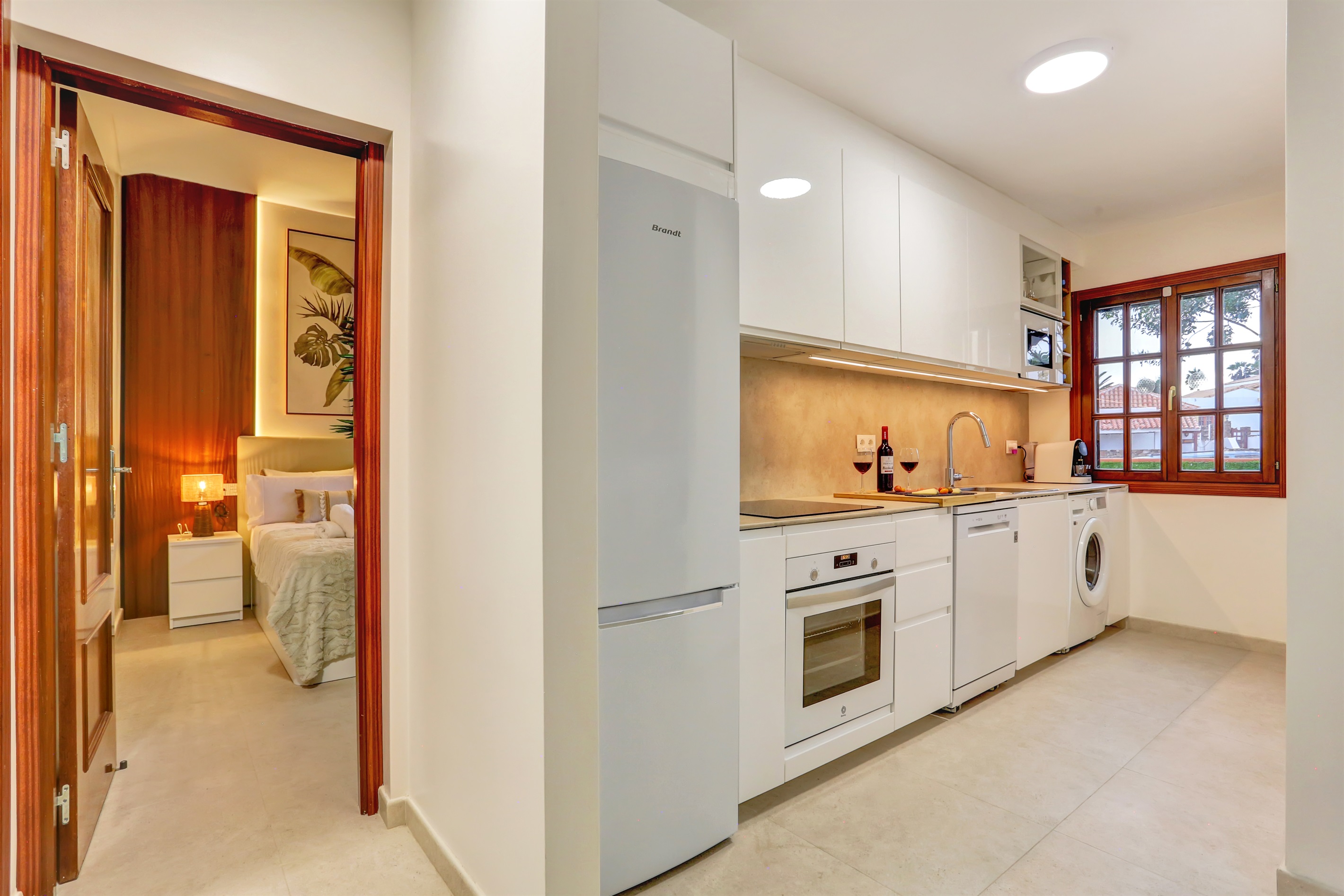 Spacious and bright fully equipped kitchen with modern appliances, seamlessly connected to the rest of the bungalow.