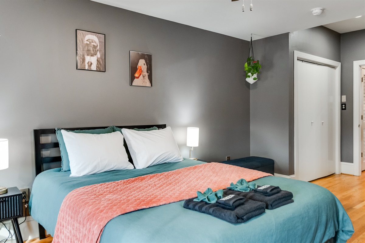 Queen Bedroom 3: Vibrant decor, plush bedding, and eclectic art for a playful, restful escape!