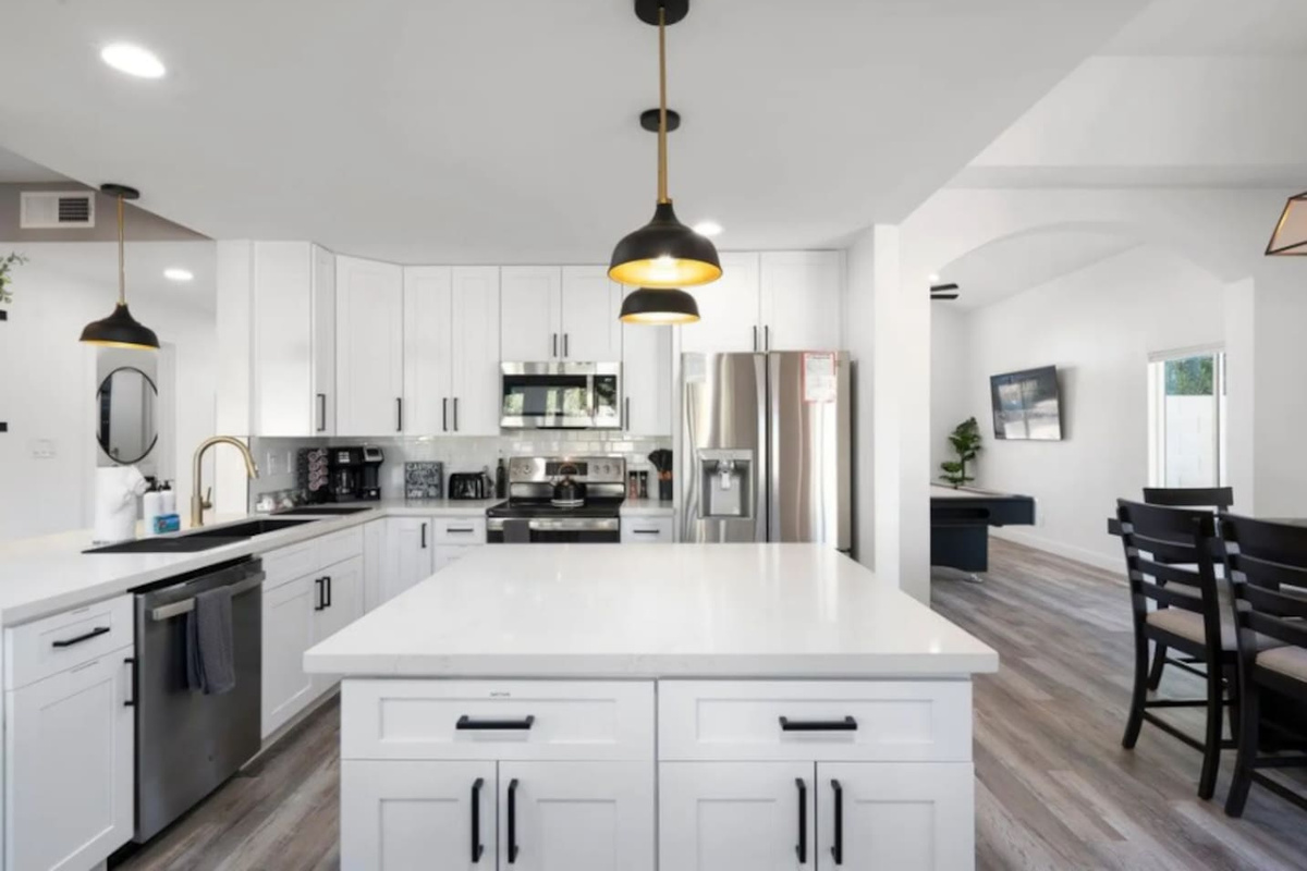 Chef's kitchen with stainless steel appliances, large island, and open floor plan perfect for cooking and entertaining.