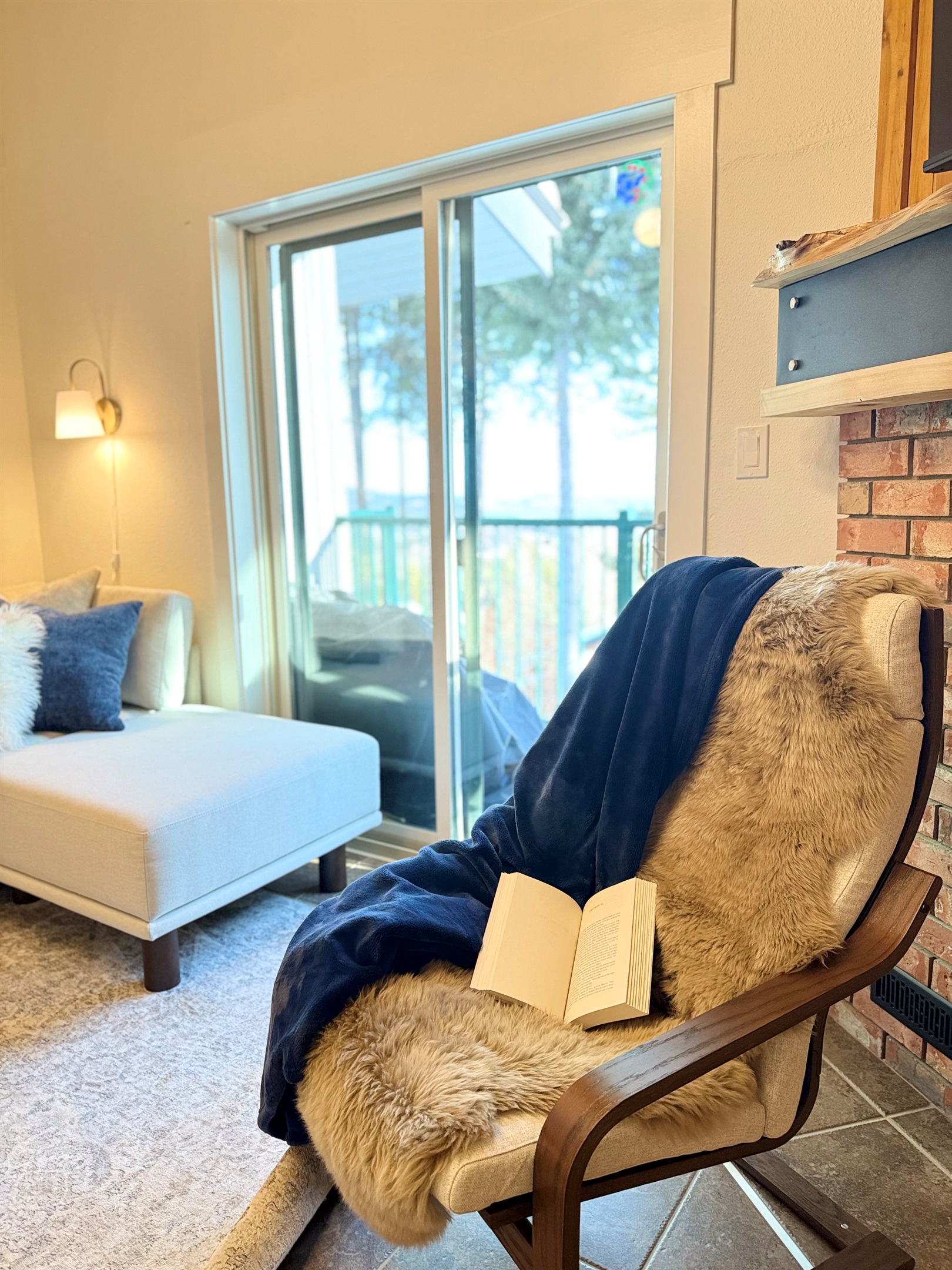 Cozy Fireside Escape: Unwind with a good book in the comfortable lounge chair by the gas fireplace in your Kimberley townhouse.