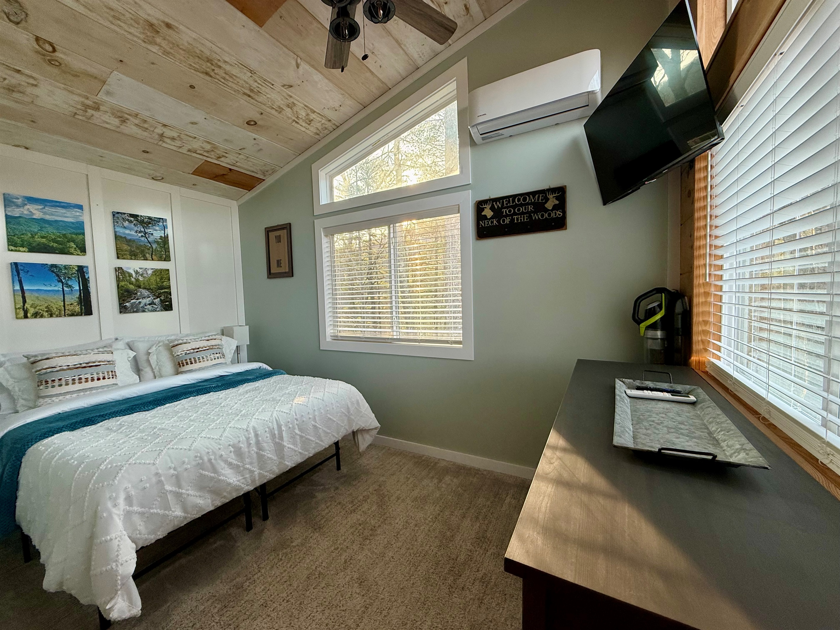 Wake up to mountain views from a memory foam queen bed dressed in luxe linens. This cozy retreat features a Smart TV, mini split for year-round comfort, ceiling fan, and dresser storage- everything you need for restful nights and slow mornings.
