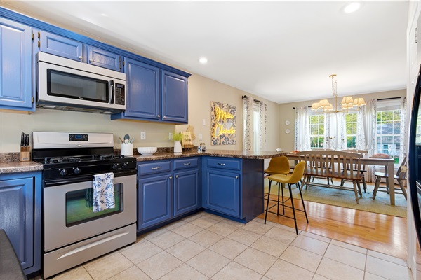 A bright and open kitchen featuring a stylish island and an adjacent dining area, designed for effortless cooking, dining, and gathering with family and friends.