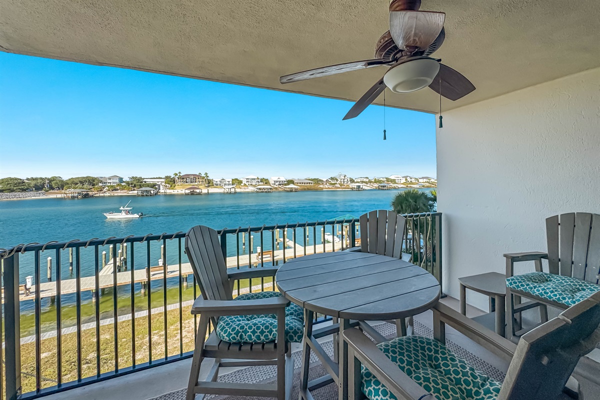 Your private oasis for outdoor dining and relaxation. This well-appointed balcony features comfortable high-top seating and a breathtaking view of the water and connecting bridge. Experience the best of waterfront living!