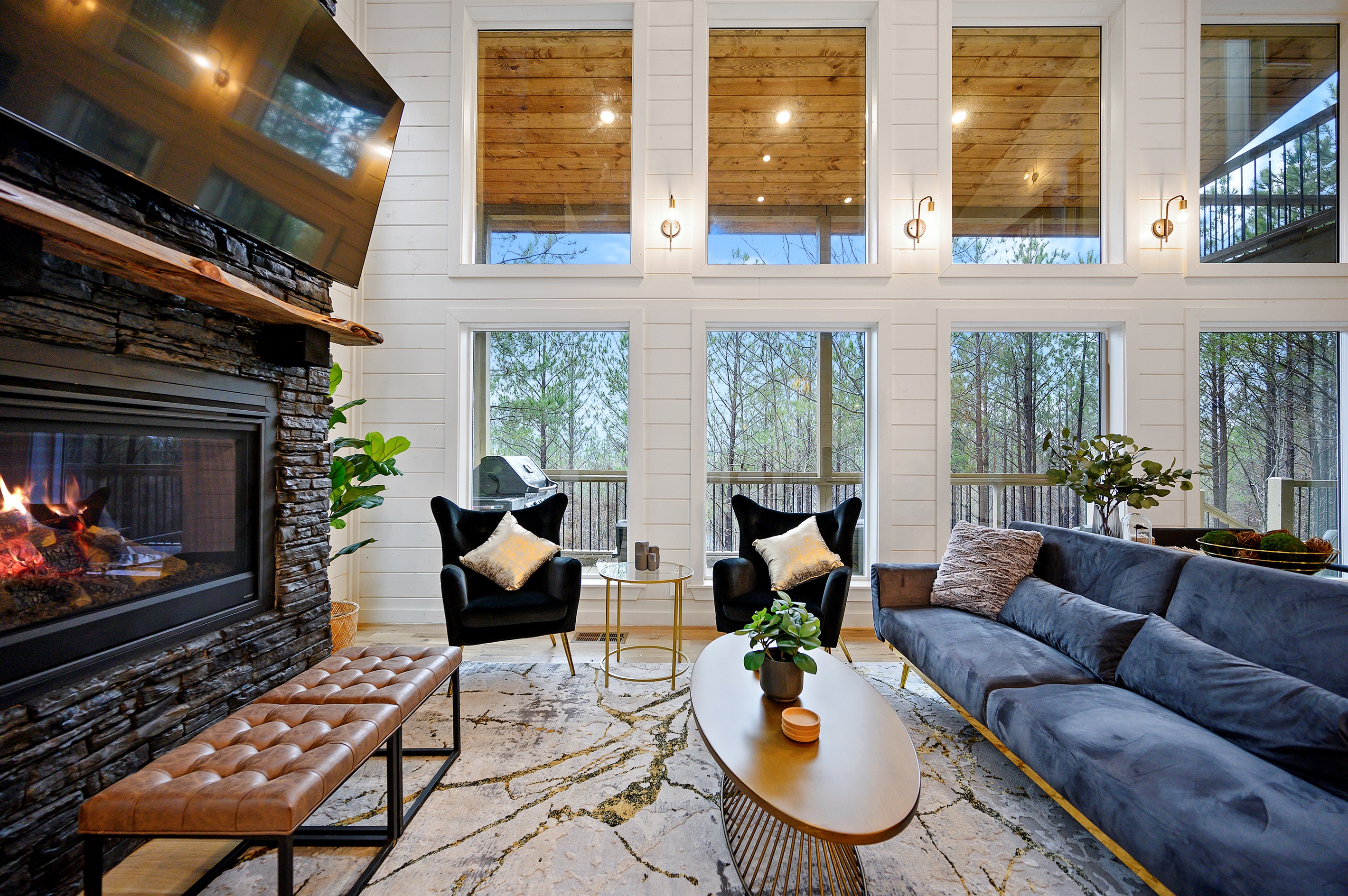 Relaxed indoor space built for connection, with cozy furnishings and a warm fireplace glow.