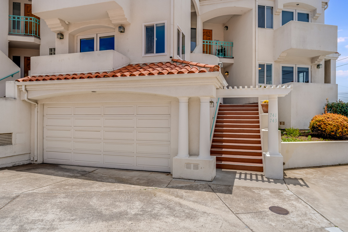 Stairs to entry - single level once inside - see double car garage in this photo